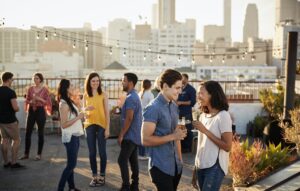 Friends Gathered On Rooftop Terrace For Party With City Skyline In Background